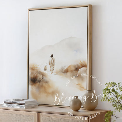 Framed Christian watercolor canvas of Jesus found lost sheep, styled on a neutral console table with modern vases and books, Blessing Brush wall art.