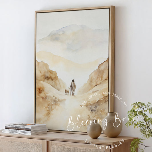 Framed Christian watercolor canvas of Jesus walking with a sheep along a mountain path, peaceful neutral-toned wall art inspired by Psalm 23, Blessing Brush.